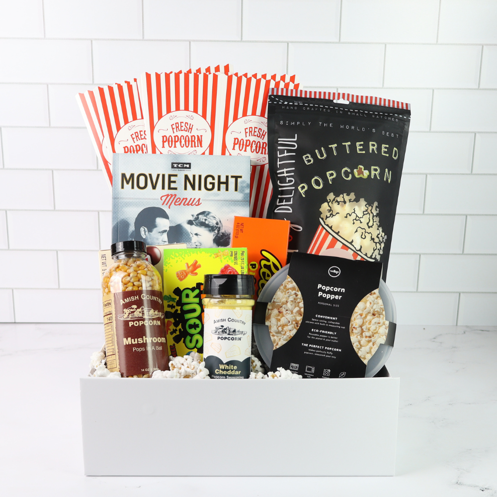 Movie night gift basket with popcorn, snacks, and a menu on a white background