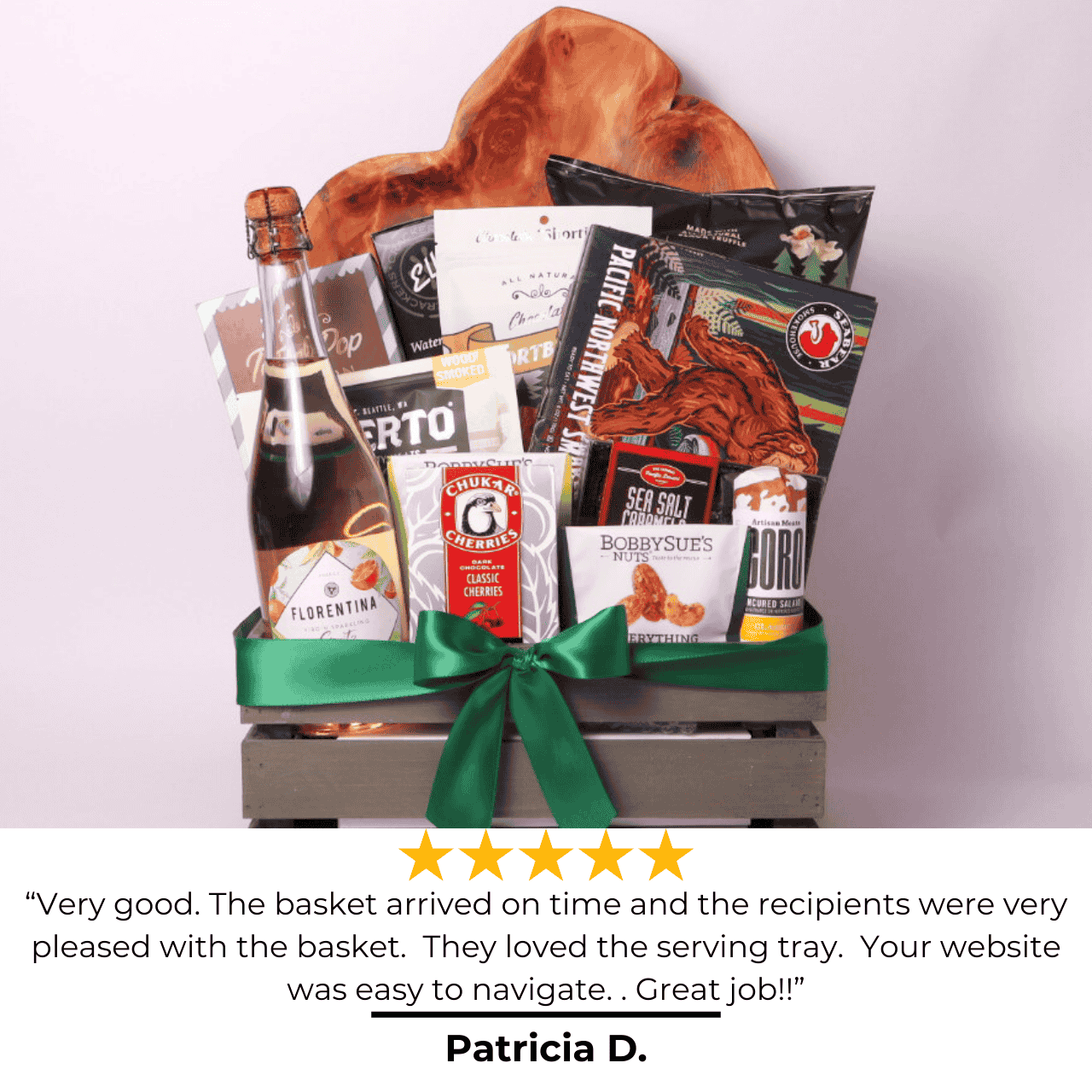 Best of the Northwest gift basket displayed with a 5-star review, featuring smoked salmon, truffle popcorn, beef jerky, salami, chocolate cherries, crackers, shortbread cookies, and a hand carved serving tray, elegantly packaged with a green ribbon.