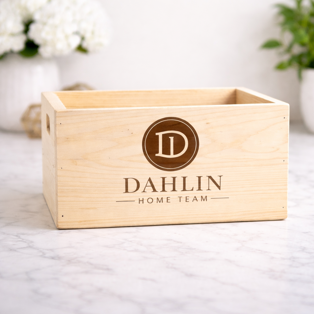 Wooden box with 'Dahlin Home Team' branding on a marble surface.