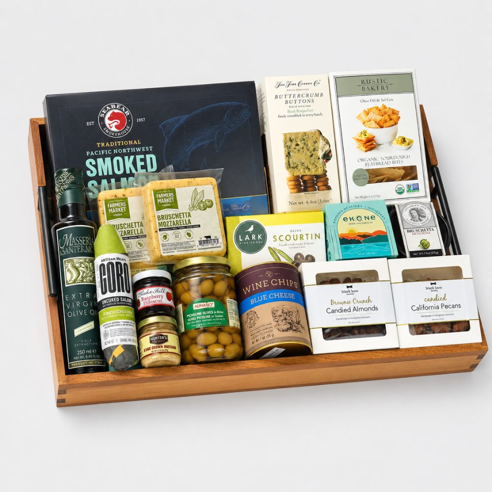 Festive holiday snack gift tray with smoked salmon, crackers, chocolates, and gourmet treats displayed with red holiday decor.