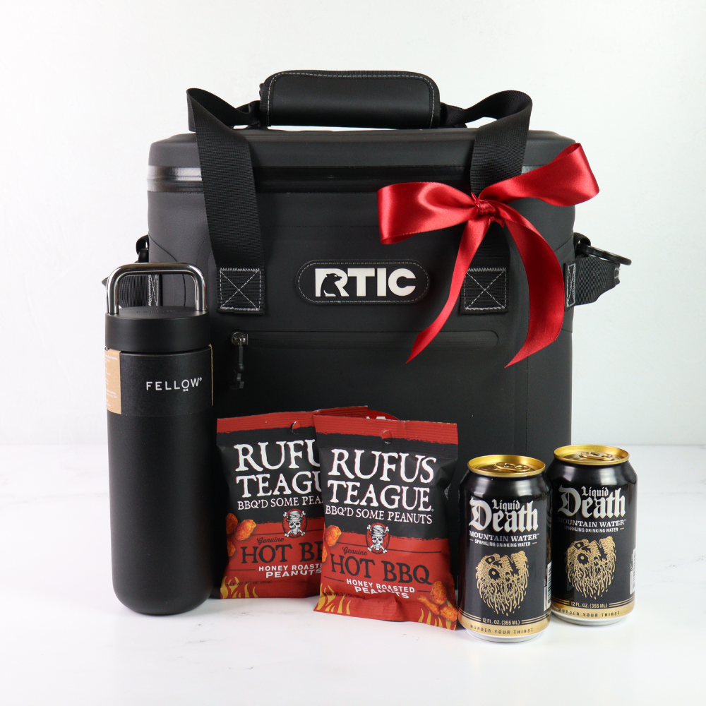Black RTIC cooler bag with a red ribbon, surrounded by Rufus Teague peanut bags and Death Wish beer cans on a white background.