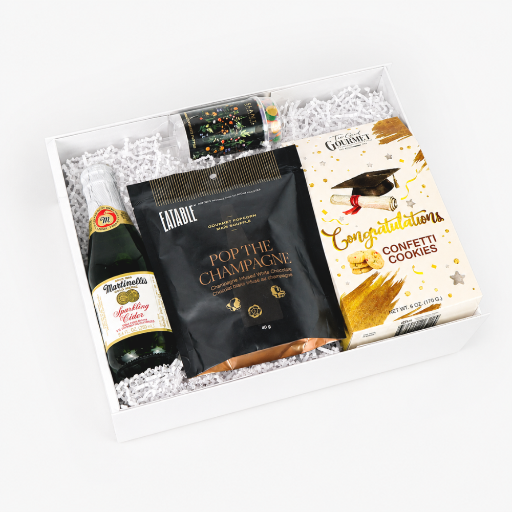 Gift basket with Martellini sparkling cider, Estable pop the champagne, and Confetti Cookies on a white background.