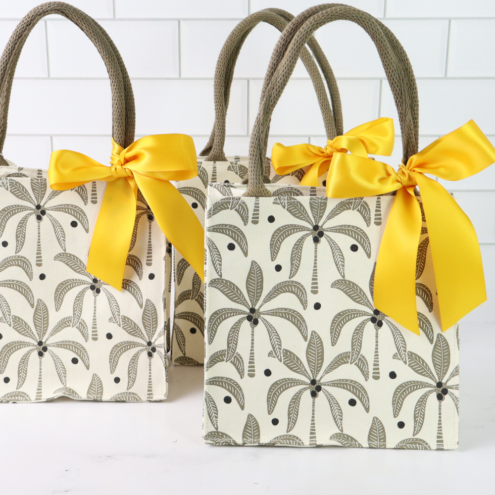 Two patterned bags with yellow ribbons on a white background