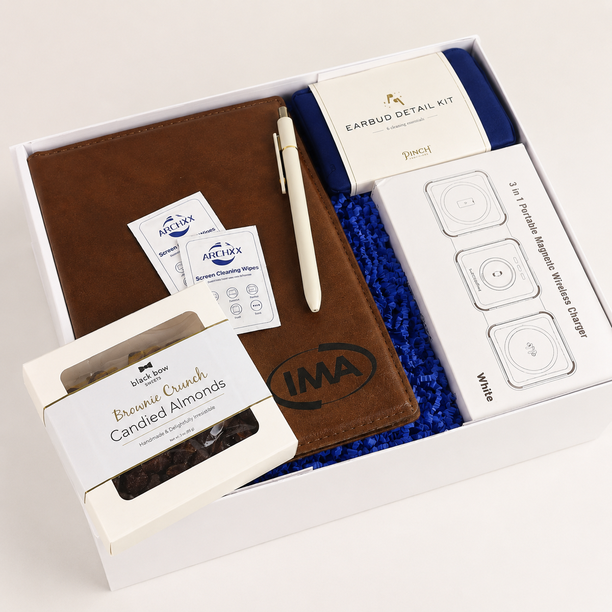 Gift set with brown leather wallet, white pen, and other items in a box.
