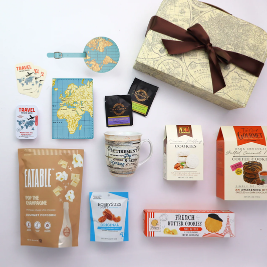 Collection of retirement gift basket items including a mug, snacks, and a decorative box on a white background