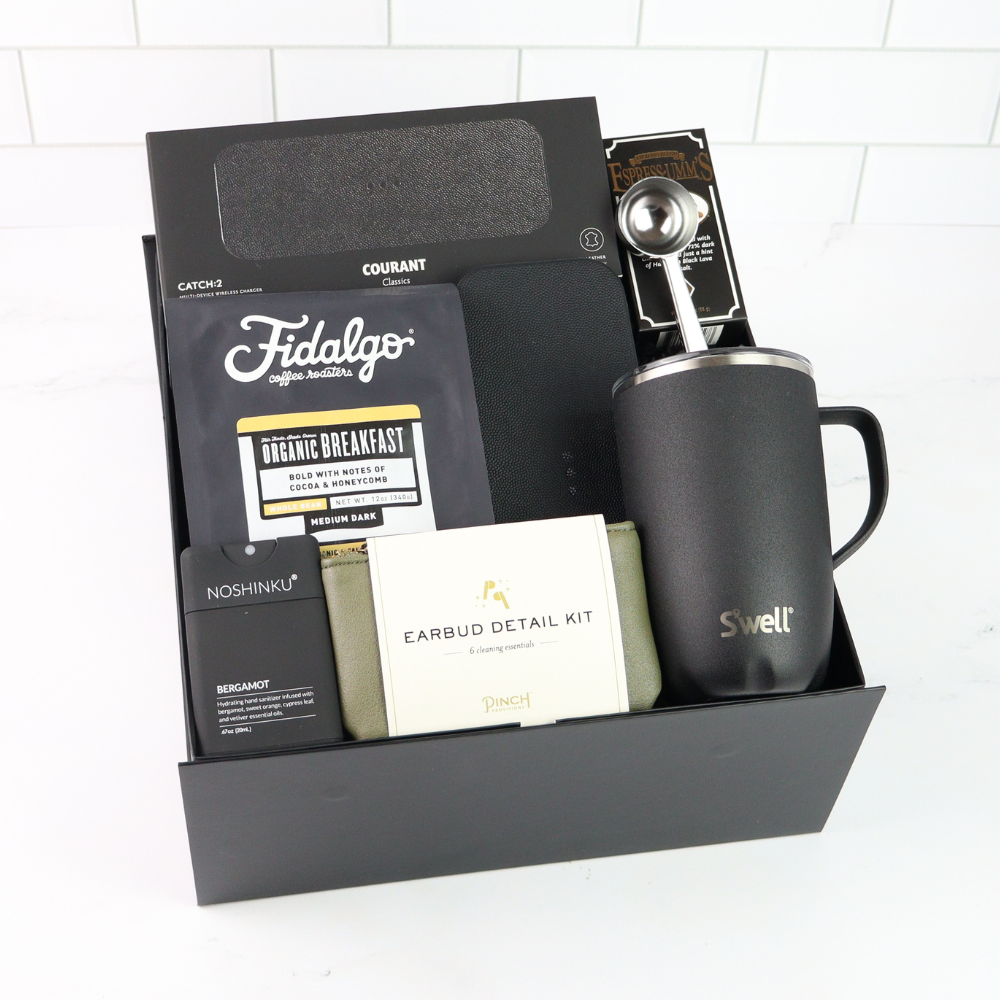 Gift set with a mug, coffee packaging, and other items on a white background