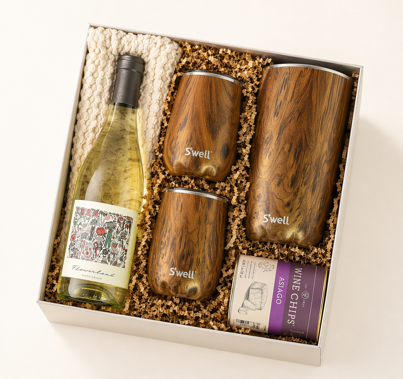 Gift set with wine bottle, 'Swell' tumblers, and wine charms in a box.