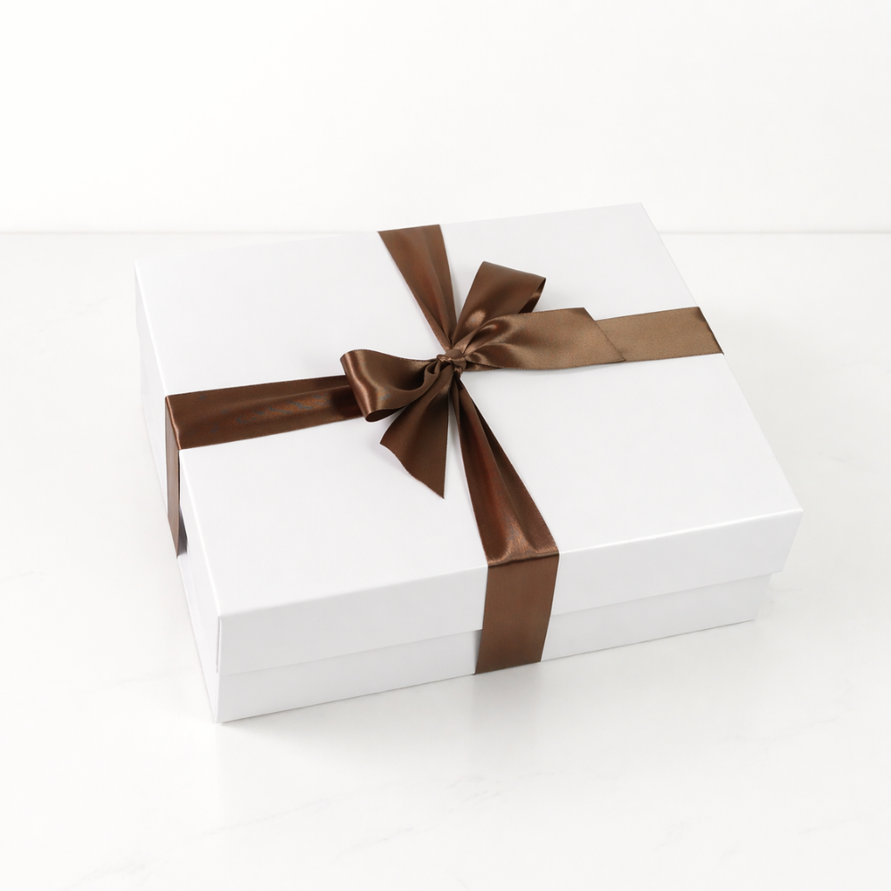 White gift box with a brown ribbon on a white background