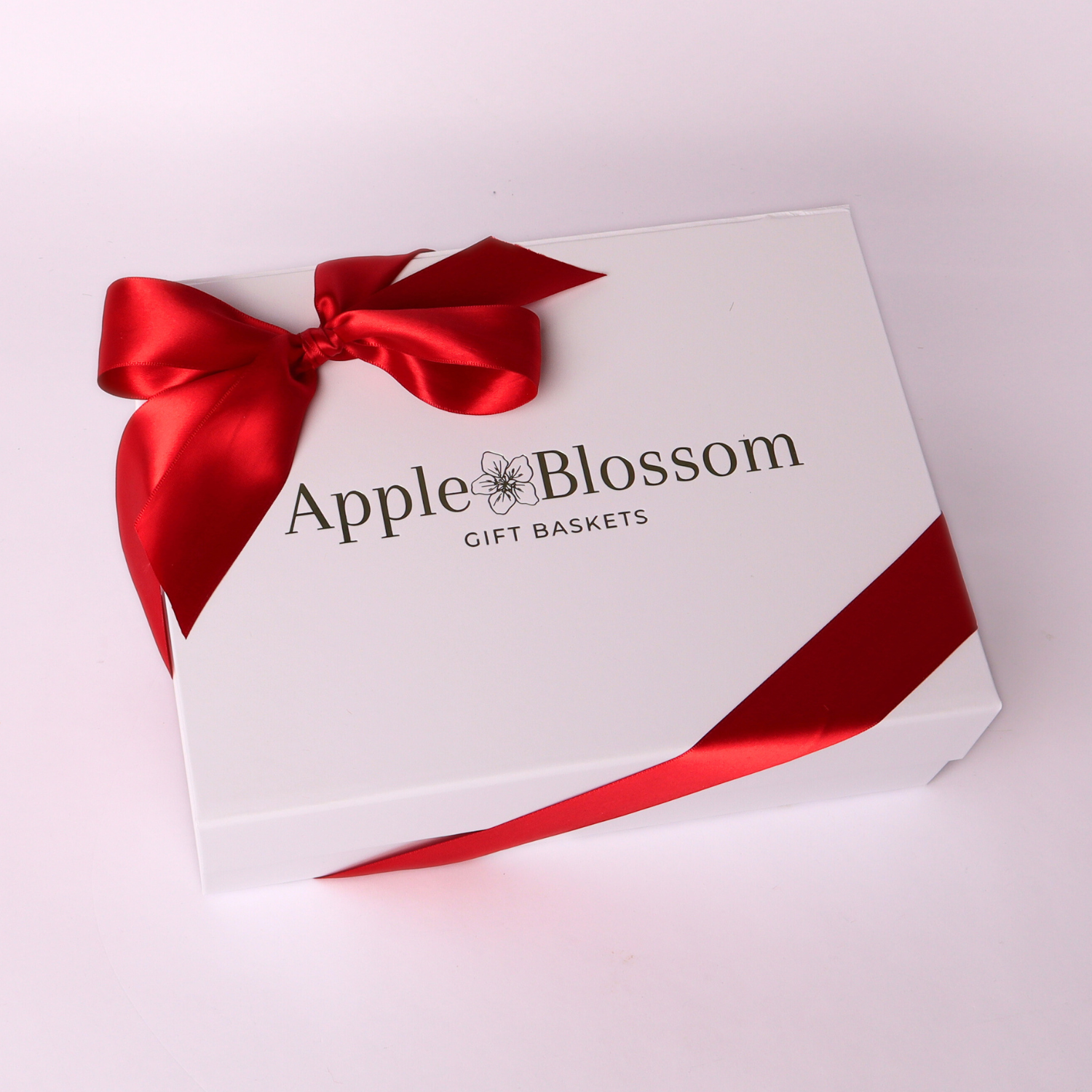 white apple blossom gift baskets signature luxe gift box with a satin red bow.